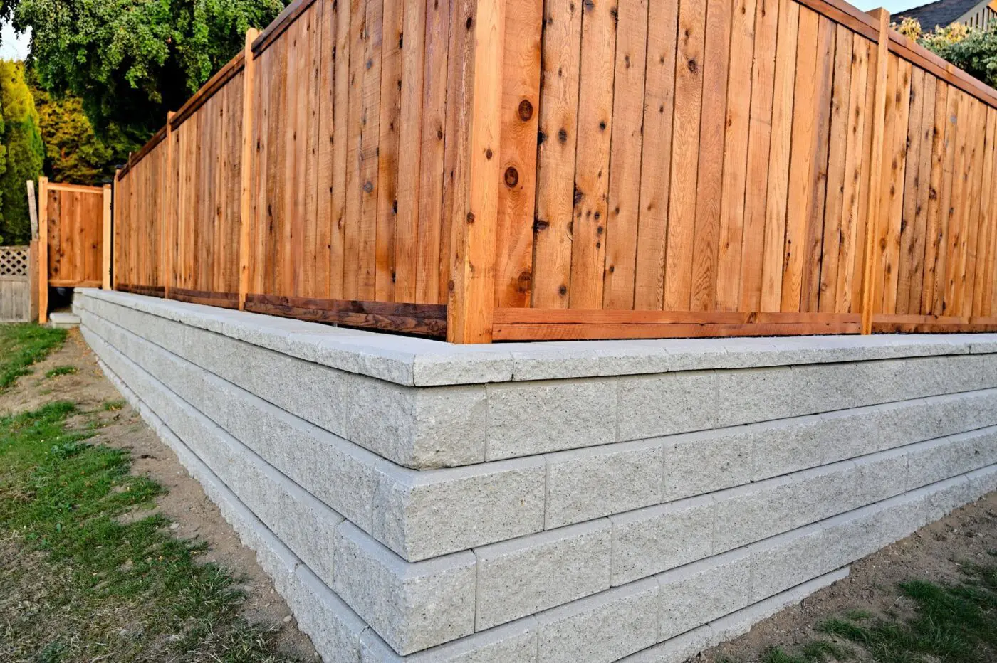 Jupiter FL retaining wall below a wooden fence