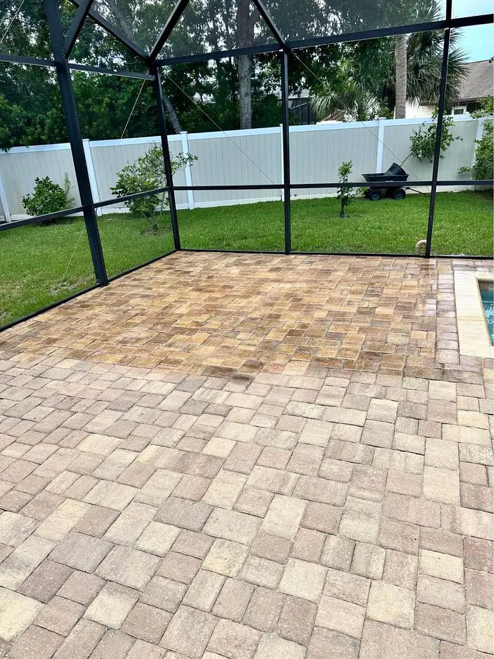 natural brick pavers in a terracotta color, half of the pavers are sealed the other half are unsealed. The paver sealing contractor stopped half way through the job to take this picture